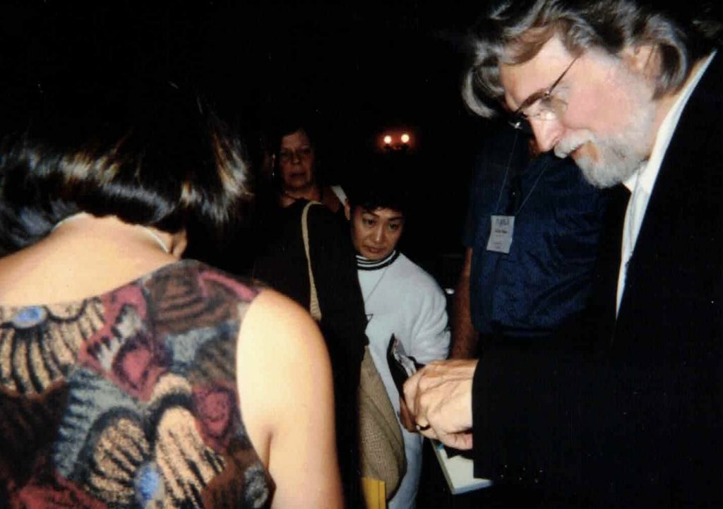 Neale Donald Walsch autographing Janine Vance's book.
